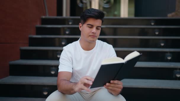 Jovem Hispânico Homem Lendo Livro Rua — Vídeo de Stock