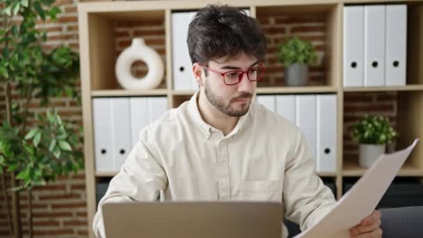 Young Hispanic Man Business Worker Using Laptop Reading Document Office — Stok video