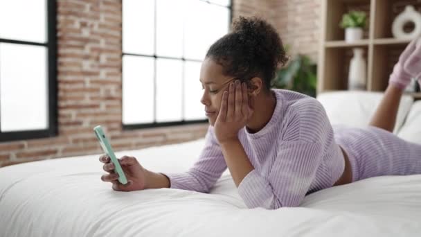 African American Woman Using Smartphone Worried Expression Bedroom — Stock Video