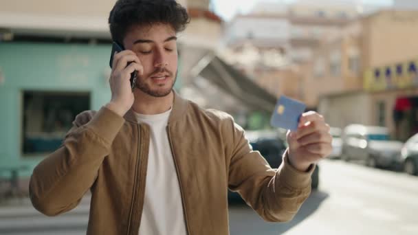 Young Hispanic Man Talking Smartphone Using Credit Card Street — Stock video