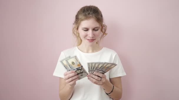 Young Blonde Woman Smiling Confident Counting Dollars Isolated Pink Background — 图库视频影像