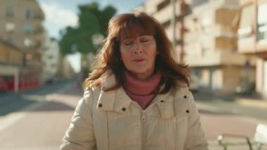 Middle age redhead woman smiling confident standing at street