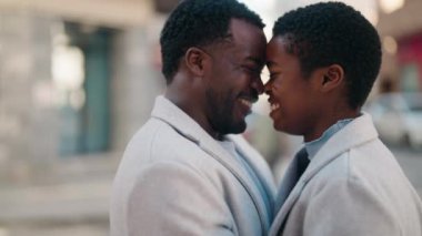 African american couple smiling confident hugging each other at street