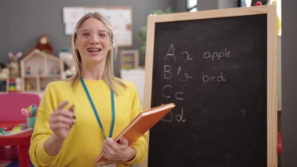 Young Blonde Woman Preschool Teacher Writing Vocabulary Exercise Blackboard Kindergarten — Wideo stockowe