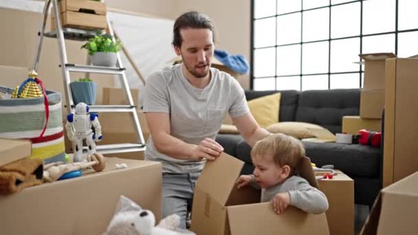 Father Son Unpacking Cardboard Box New Home — Stock Video
