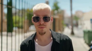 Young caucasian man smiling confident standing at street