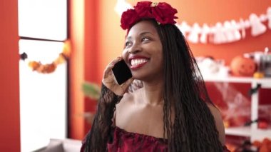 African woman wearing katrina costume at home