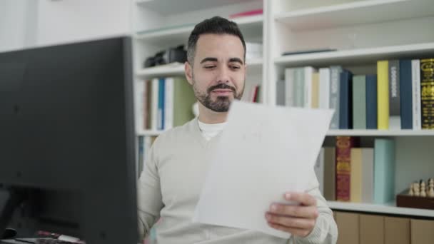 Young Hispanic Man Student Using Computer Reading Document Library University — Stockvideo