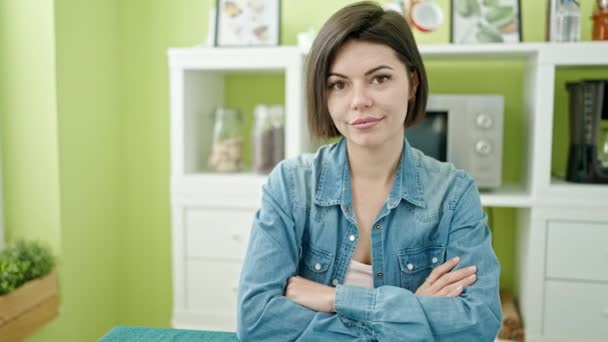 Young Caucasian Woman Smiling Confident Sitting Table Arms Crossed Gesture – Stock-video