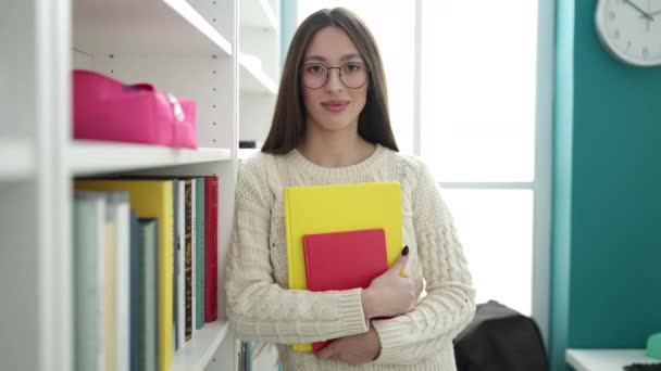 Young Beautiful Hispanic Woman Standing Holding Books Library University — Stockvideo