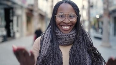 African woman smiling confident asking to come at street