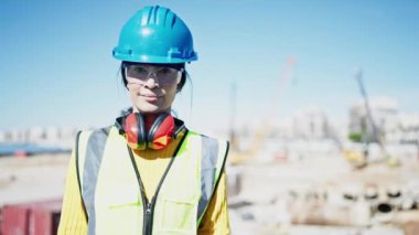 Young beautiful hispanic woman architect smiling confident standing at street