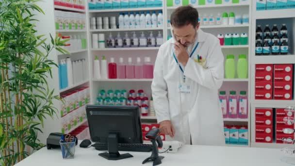 Middle Age Man Pharmacist Talking Telephone Using Computer Pharmacy — Vídeo de Stock