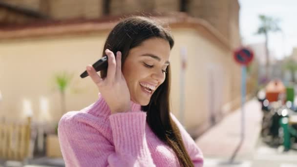 Jovem Hispânica Sorrindo Confiante Ouvir Mensagem Áudio Pelo Smartphone Rua — Vídeo de Stock