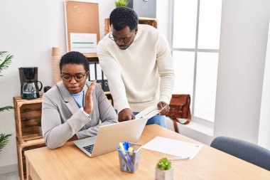 Man and woman business workers using laptop working at office