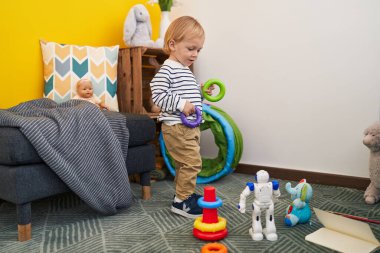 Kafkasyalı sevimli çocuk elinde potalarla evde dikiliyor.