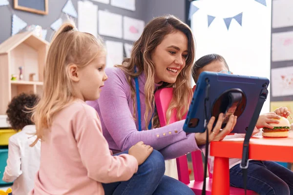 stock image Woman with boy and girl having lesson using touchpad at kindergarten