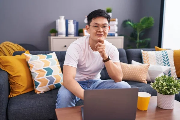 Young Asian Man Using Laptop Home Sitting Sofa Hand Chin — Stock Photo, Image