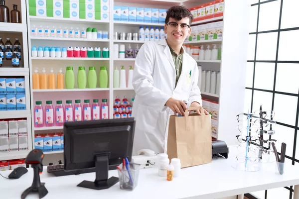 Non Binary Man Pharmacist Putting Products Shopping Bag Pharmacy — Stockfoto