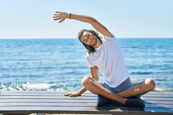 Young Hispanic Man Doing Yoga Exercise Sitting Bench Seaside — Fotografia de Stock