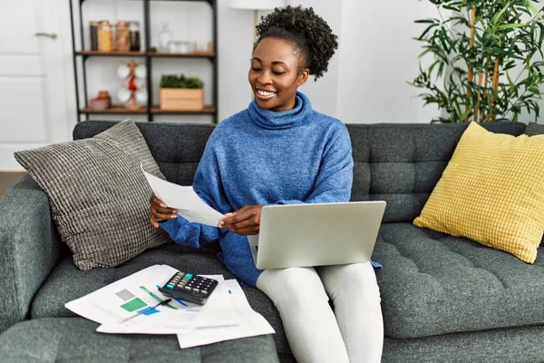 African American Woman Reading Document Using Laptop Accounting Home — Stockfoto