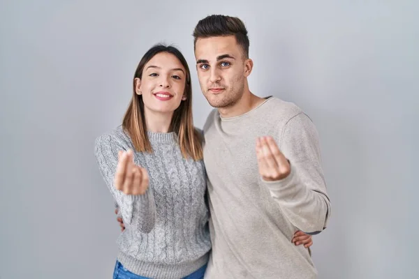 Young Hispanic Couple Standing White Background Doing Money Gesture Hands — Stock Photo, Image