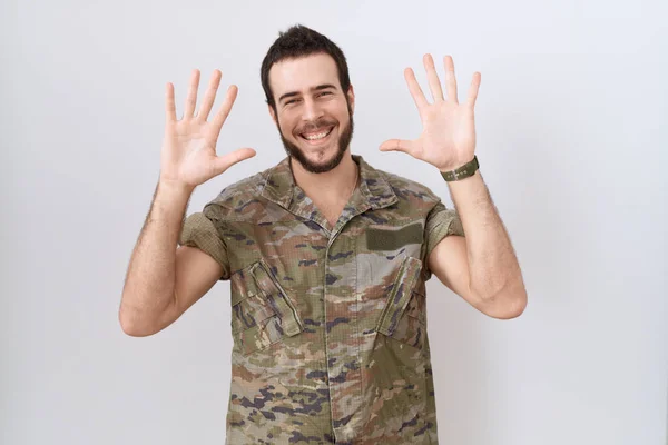 Young Hispanic Man Wearing Camouflage Army Uniform Showing Pointing Fingers — Photo