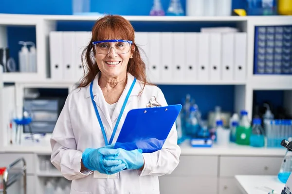 Mulher Meia Idade Cientista Sorrindo Confiante Segurando Checklist Laboratório — Fotografia de Stock