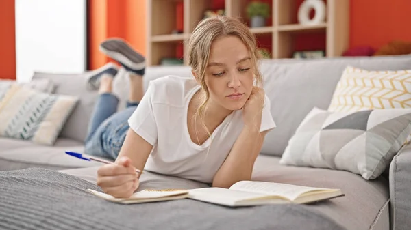 Young Blonde Woman Reading Book Writing Notebook Home — Stock Photo, Image
