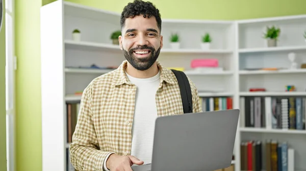 Kütüphanede Dizüstü Bilgisayar Kullanarak Gülümseyen Spanyol Asıllı Genç Bir Öğrenci — Stok fotoğraf