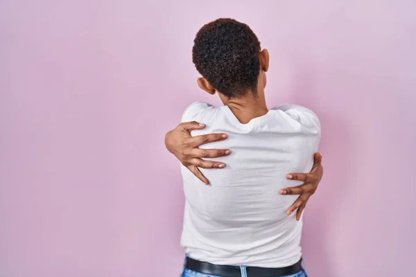 Beautiful African American Woman Standing Pink Background Hugging Oneself Happy — Stock Photo, Image
