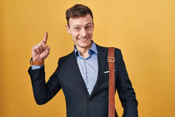 Caucasian Business Man Yellow Background Smiling Amazed Surprised Pointing Fingers — Stock Photo, Image