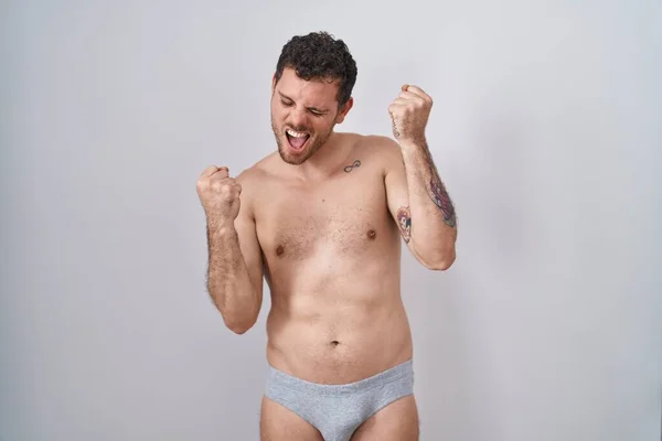 Young Hispanic Man Standing Shirtless Wearing Underware Celebrating Surprised Amazed — Stock Photo, Image
