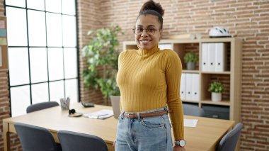 Young african american woman smiling confident wearing glasses at office