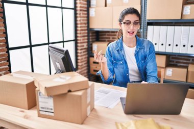 Young beautiful hispanic woman ecommerce business worker having video call at office