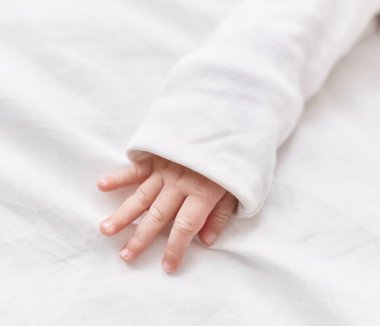 Adorable caucasian baby lying on bed at bedroom