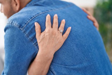 Man and woman mother and son hugging each other at home