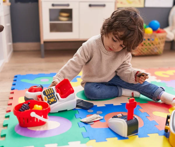 stock image Adorable hispanic boy playing supermarket game sitting on floor at kindergarten