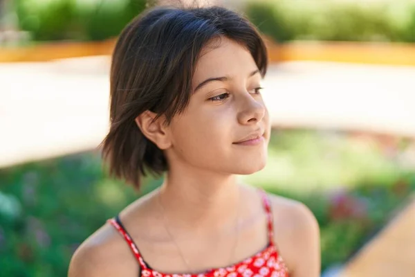 stock image Adorable hispanic girl looking to the side with serious expression at park