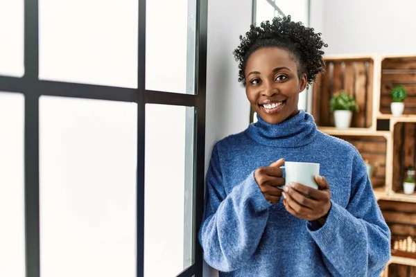 African American Woman Drinking Coffee Leaning Window Home — Stockfoto