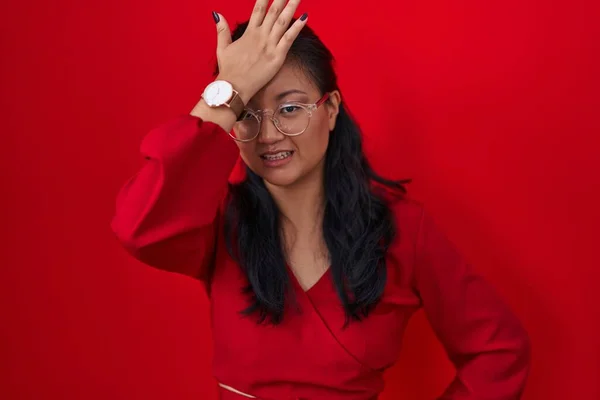 Asiatisk Ung Kvinna Står Över Röd Bakgrund Överraskad Med Handen — Stockfoto
