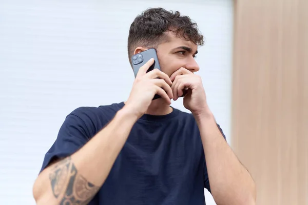 Young Hispanic Man Talking Smartphone Serious Expression Street — Stok fotoğraf