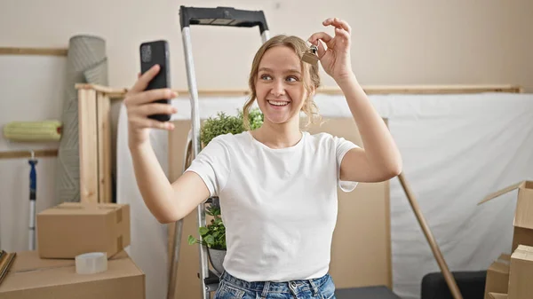 Young Blonde Woman Having Video Call Holding Key New Home — Stockfoto