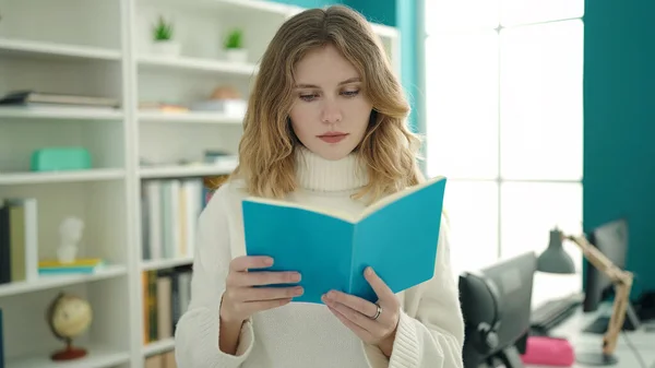 Young Blonde Woman Student Reading Book Standing Library University — Stockfoto