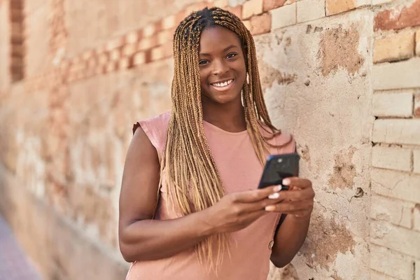 Αφροαμερικανή Γυναίκα Χαμογελώντας Αυτοπεποίθηση Χρησιμοποιώντας Smartphone Πάνω Από Απομονωμένο Πέτρινο — Φωτογραφία Αρχείου