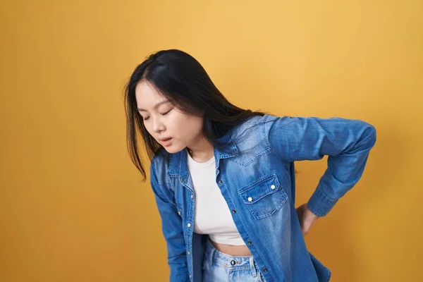 Young Asian Woman Standing Yellow Background Suffering Backache Touching Back — Stock Photo, Image