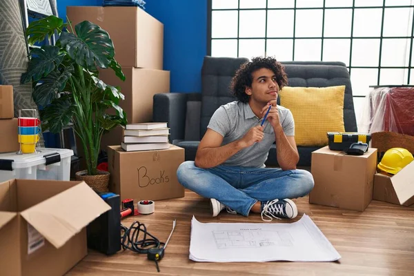 Young Hispanic Man Having Idea Writing House Plan New Home — Stockfoto
