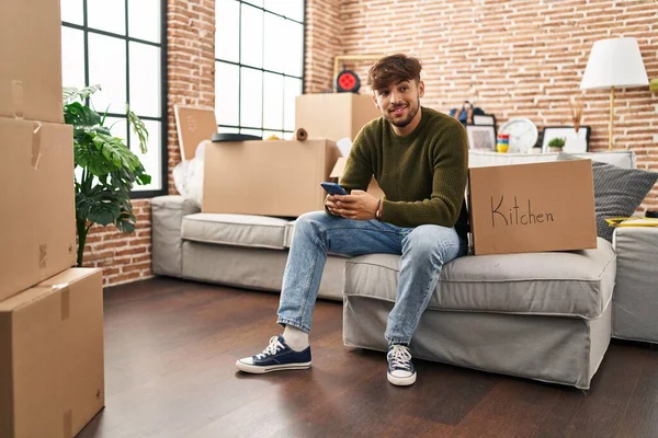 Junger Araber Sitzt Mit Smartphone Auf Sofa Neuen Zuhause — Stockfoto