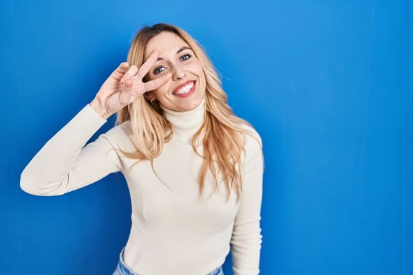 Young Caucasian Woman Standing Blue Background Doing Peace Symbol Fingers — Foto Stock