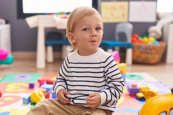 Adorable Caucasian Boy Sitting Floor Relaxed Expression Kindergarten — Stock Photo, Image